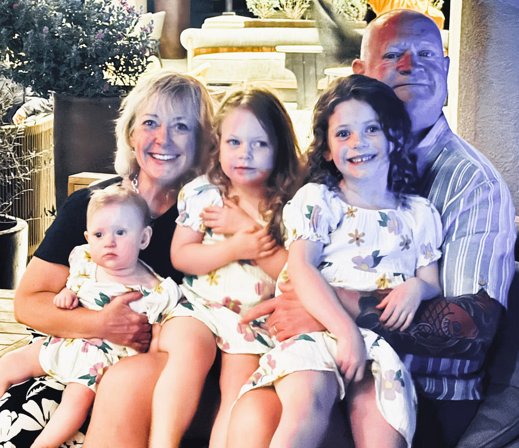 Mark and Lesley with their three grandchildren
