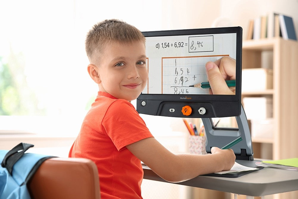 Reveil 16 - A picture of a young boy using his Reveal 16 to solve math problems at home. 